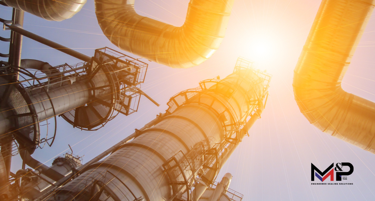 Bright summer sun shining over an industrial refinery, highlighting the extreme operating temperatures that can affect gasket performance and sealing reliability.